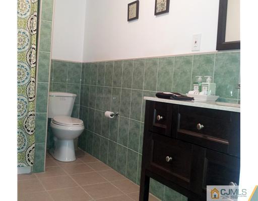3 Monaghan Road Edison, NJ 08817 - Photo 8 of 16 a bathroom with a toilet a sink and mirror