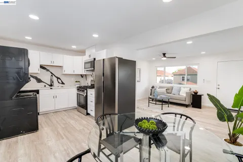 a kitchen with stainless steel appliances a refrigerator and a dining table