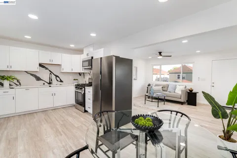 a kitchen with stainless steel appliances a refrigerator and a dining table