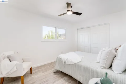 a bedroom with a bed and a chair