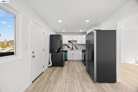 a view of a refrigerator in kitchen and wooden floor