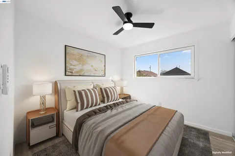 a bedroom with a bed and a painting on the wall