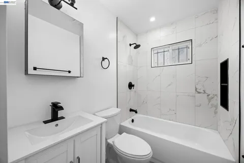 a bathroom with a sink a toilet and bathtub