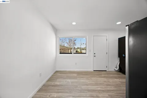a view of a hallway with wooden floor