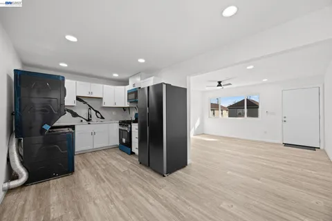 a kitchen with stainless steel appliances a refrigerator and a microwave