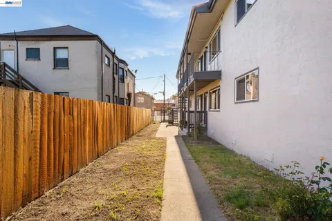 a view of a pathway of a house with wooden stairs