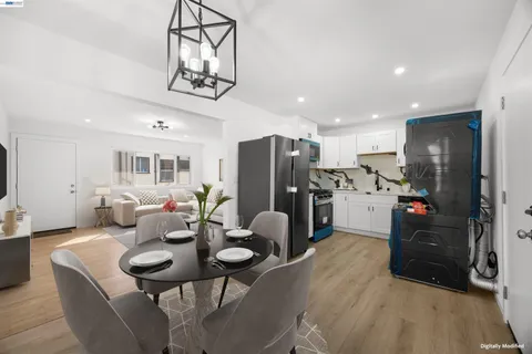 a living room with stainless steel appliances kitchen island granite countertop furniture and a refrigerator