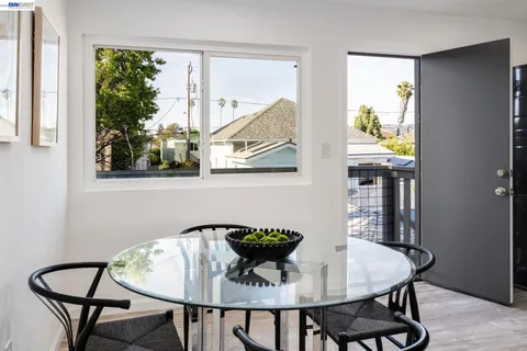 a view of a dining room with furniture and window