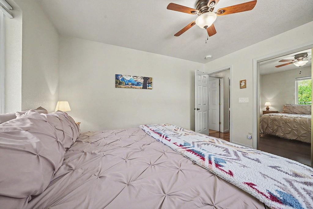 26845 Spring Court Pioneer, CA 95666 - Photo 29 of 89 a bedroom with a large bed and a chandelier