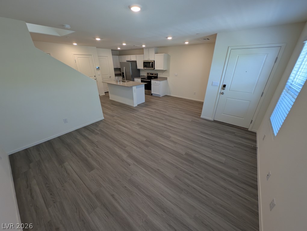 4820 Orchid Rdg Avenue Las Vegas, NV 89141 - Photo 5 of 27 Modern kitchen with stainless steel appliances adjoins a spacious living area, ideal for relaxed entertaining.