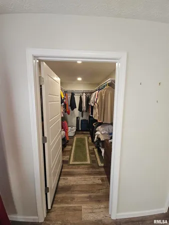 a view of a hallway with wooden floor and stairs