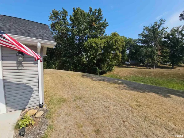 a backyard of a house with lots of green space