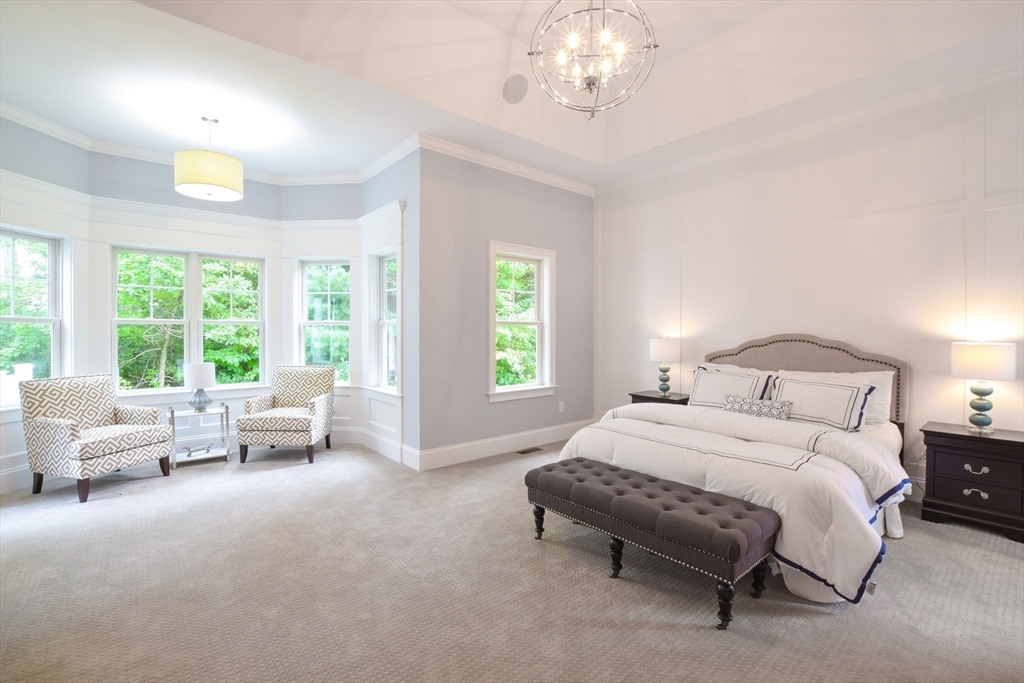 0 Diesel Lot-3 Lincoln, RI 02865 - Photo 4 of 10 a spacious bedroom with a bed and a chandelier