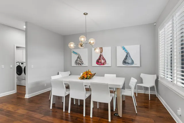 a view of a dining room with furniture wooden floor and chandelier