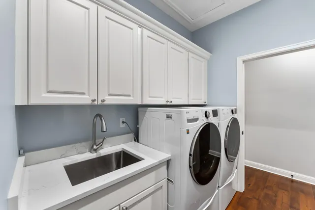 a utility room with sink dryer and washer