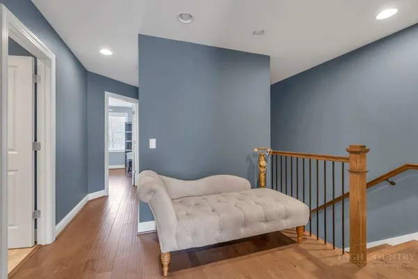 a large bed sitting in a bedroom next to a window