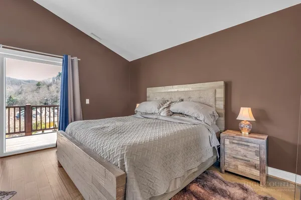 a bedroom with a bed and a large window