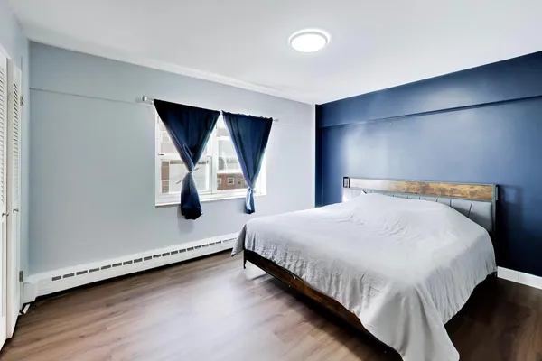 a view of an empty room with wooden floor