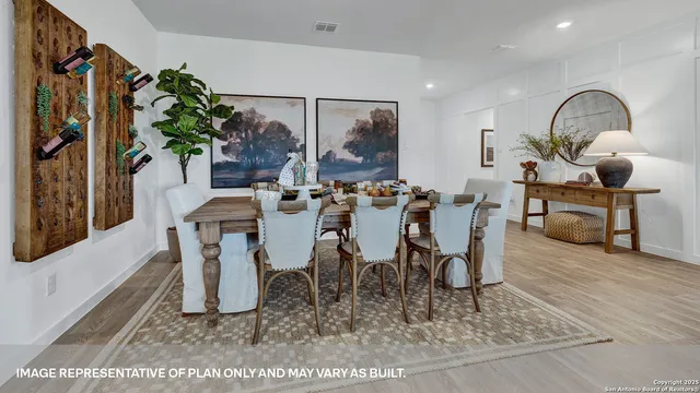 a living room with kitchen furniture and a wooden floor