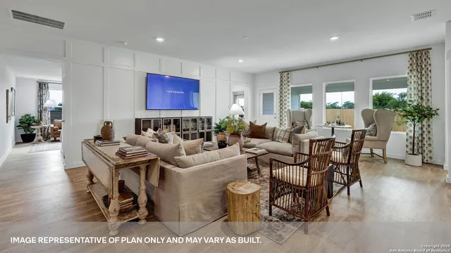 a living room with furniture a rug and a flat screen tv