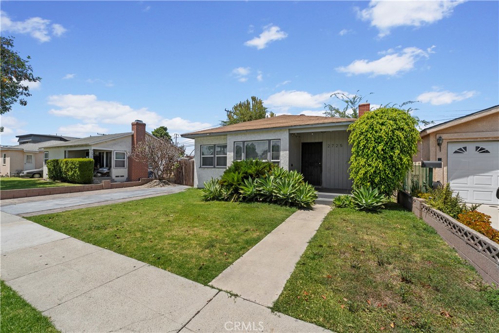2725 East Tyler Street Carson, CA 90810 - Photo 24 of 30 a front view of a house with garden