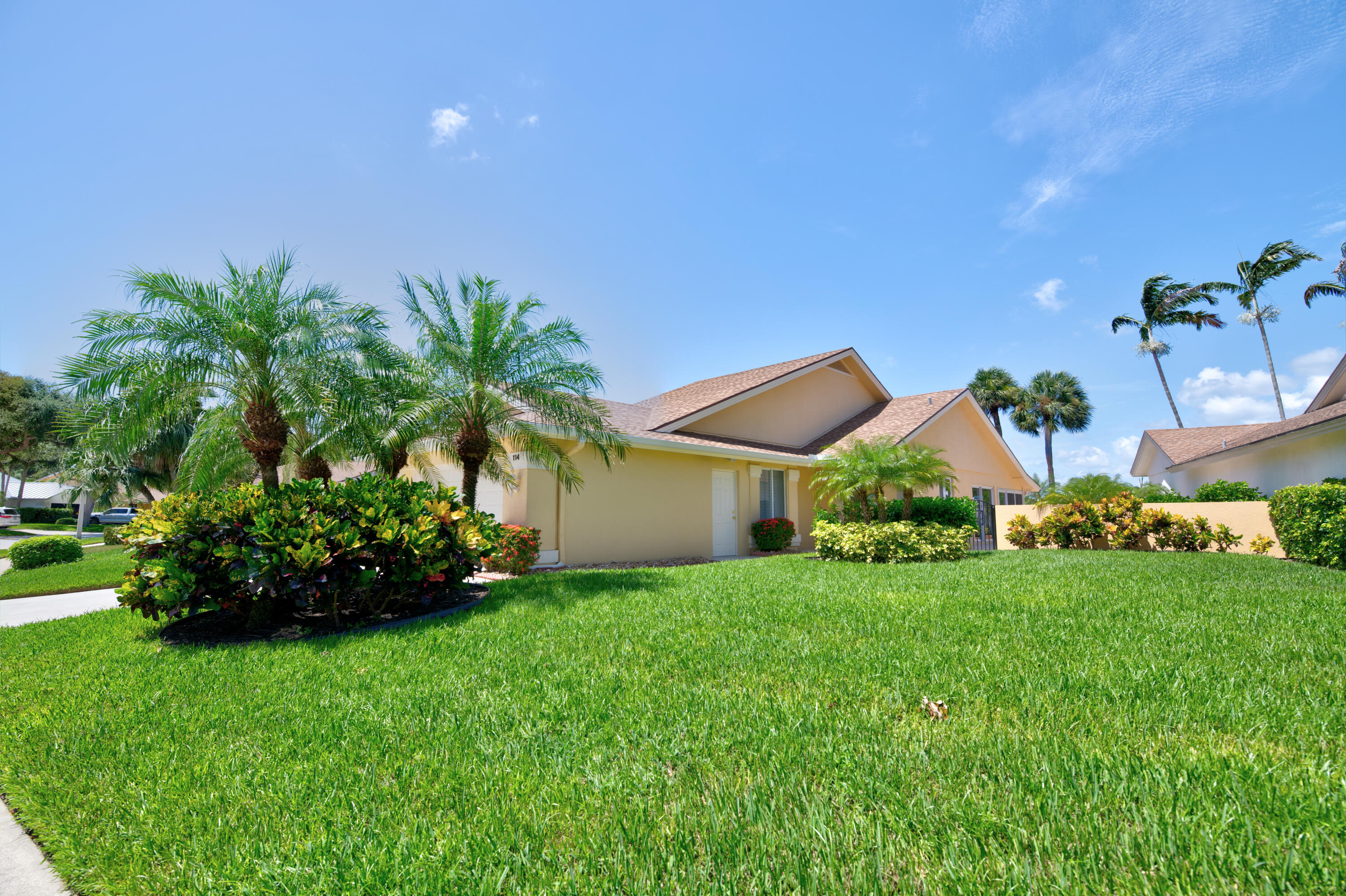 114 Beach Summit Court Jupiter, FL 33477 - Photo 8 of 97 a front view of a house with a garden