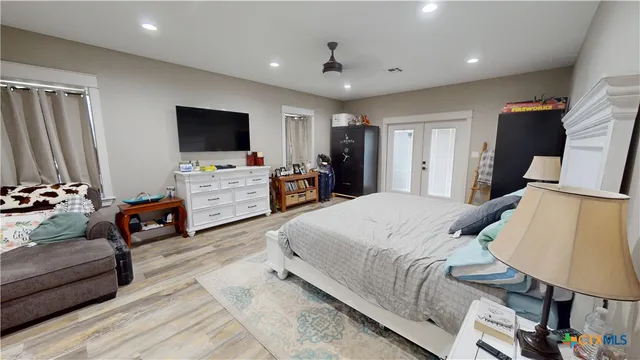 a bedroom with furniture and a flat screen tv