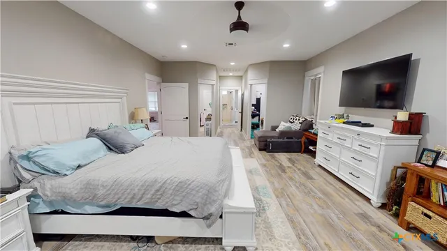 a bedroom with a bed and a flat screen tv