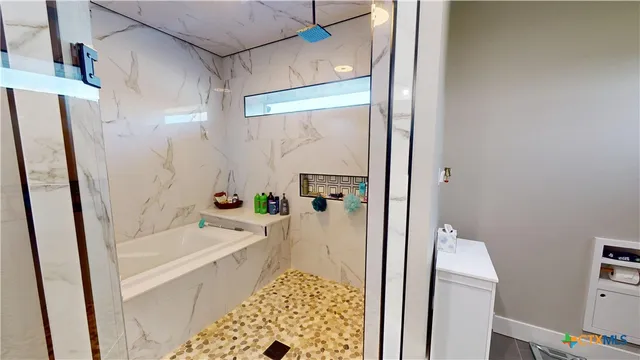 a bathroom with a bathtub and a shower
