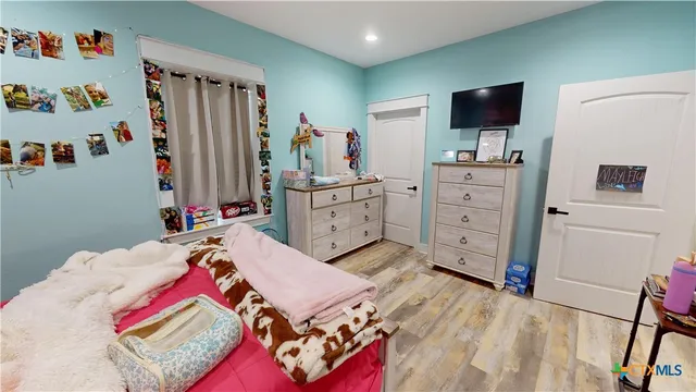 a bed room with a bed and a television