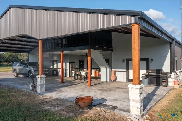 a view of a patio with table and chairs with wooden fence and floor