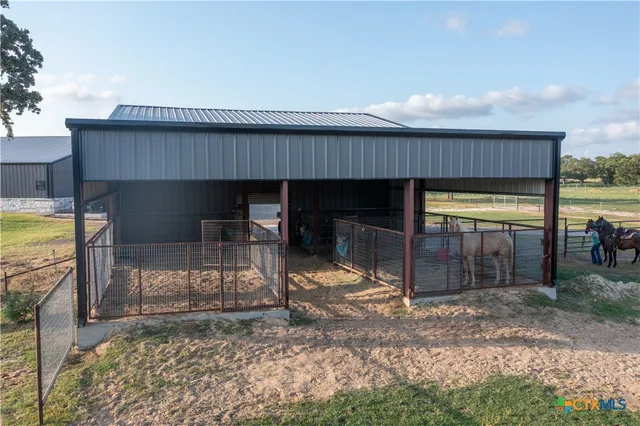 a view of a house with a porch and furniture
