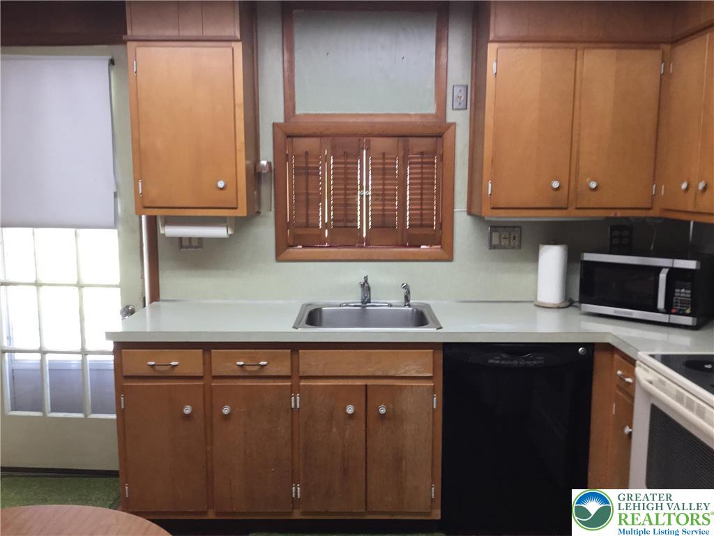1105 Main Street Slatington, PA 18080 - Photo 13 of 31 Functional kitchen with ample cabinetry and a convenient sink, ready for culinary endeavors.