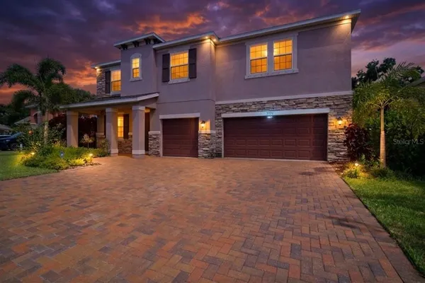 an aerial view of a house with yard swimming pool and outdoor seating