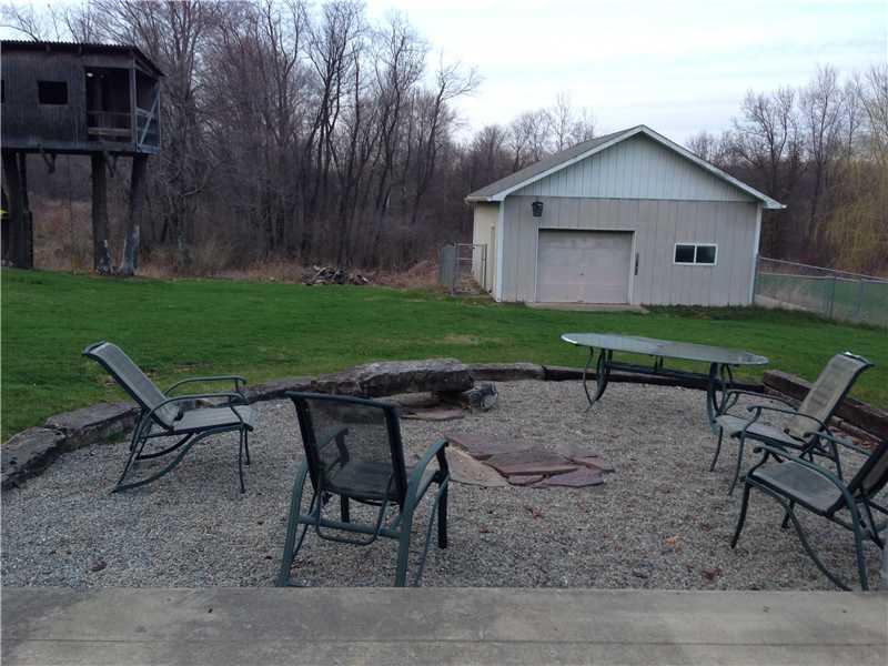 575 Cannery Road Mercer, PA 16137 - Photo 10 of 13 Exterior Back. Tree house, Fire pit area, and Detached garage