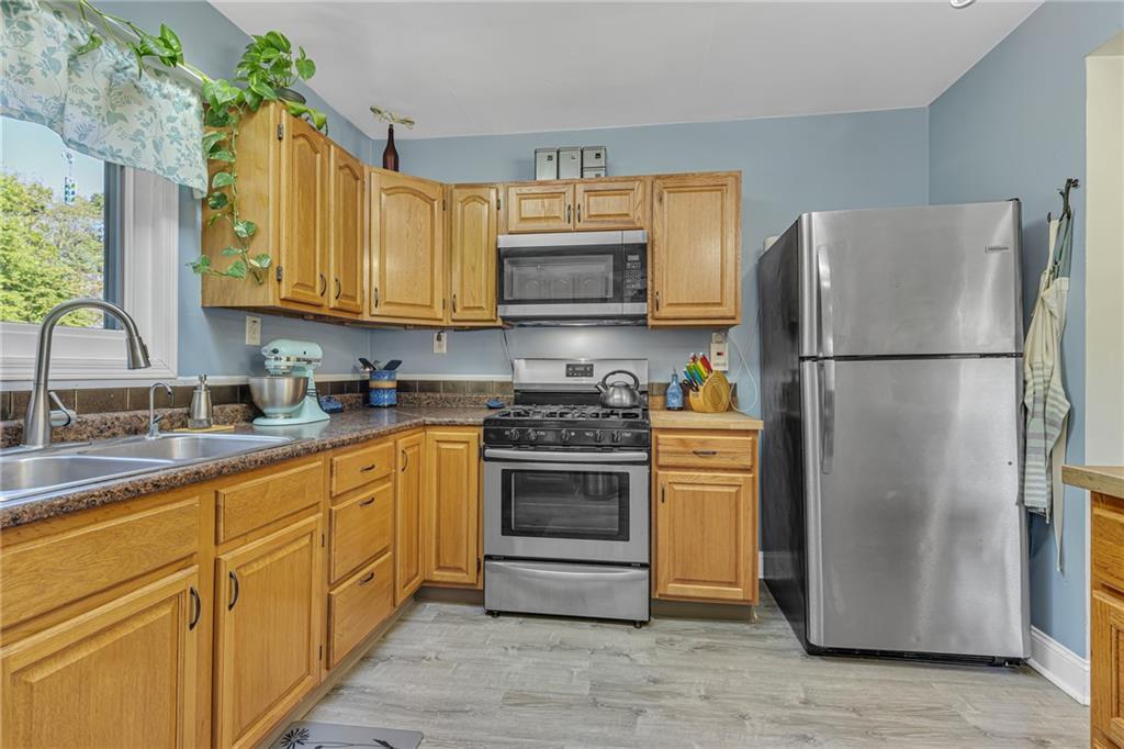 3430 37th St Extension Beaver Falls, PA 15010 - Photo 14 of 31 a kitchen with a refrigerator sink and cabinets