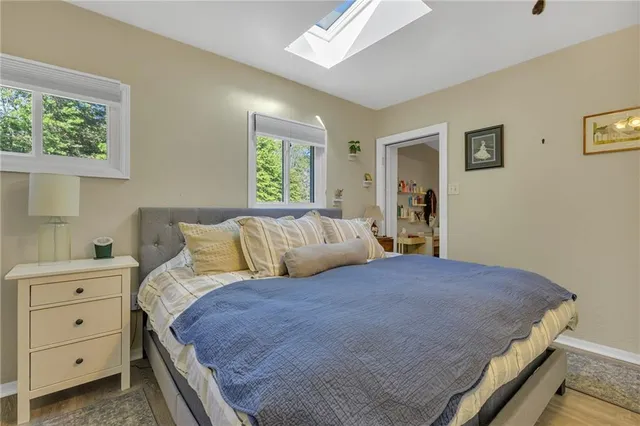 a bedroom with a large bed and a window