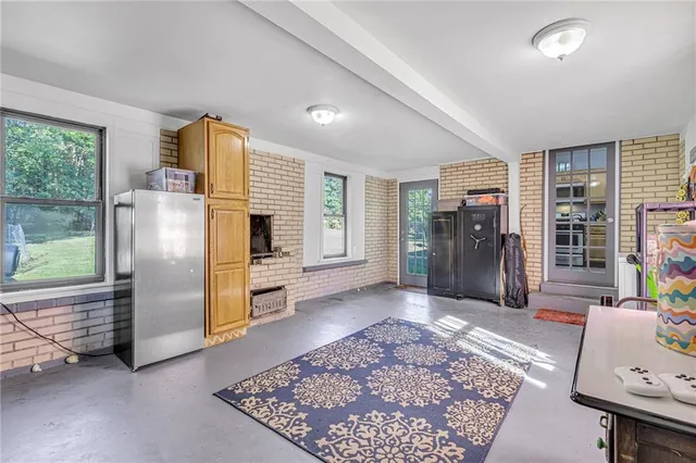 a view of a livingroom with furniture window and a kitchen