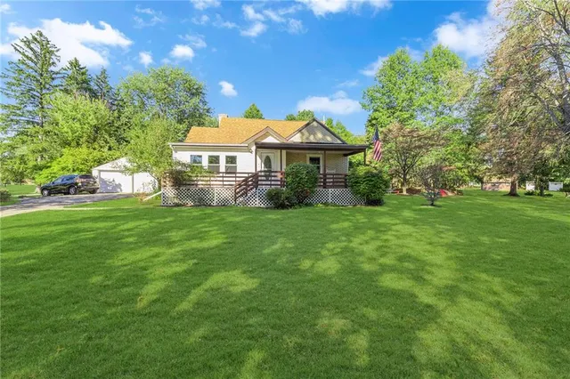 a view of a house with a yard and garden