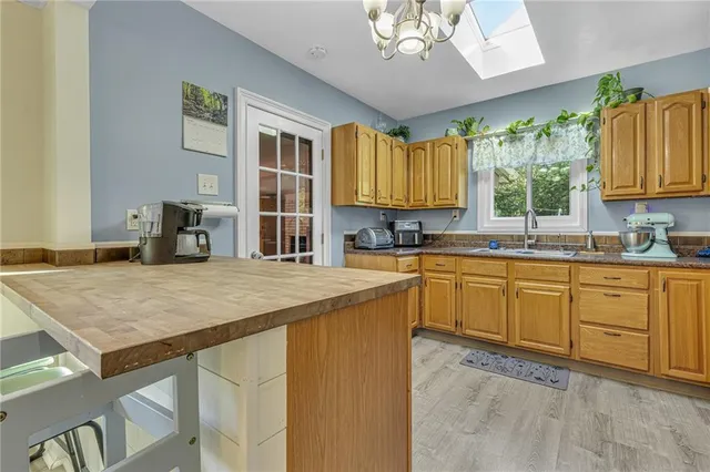 a kitchen with a stove a sink a dining table and chairs