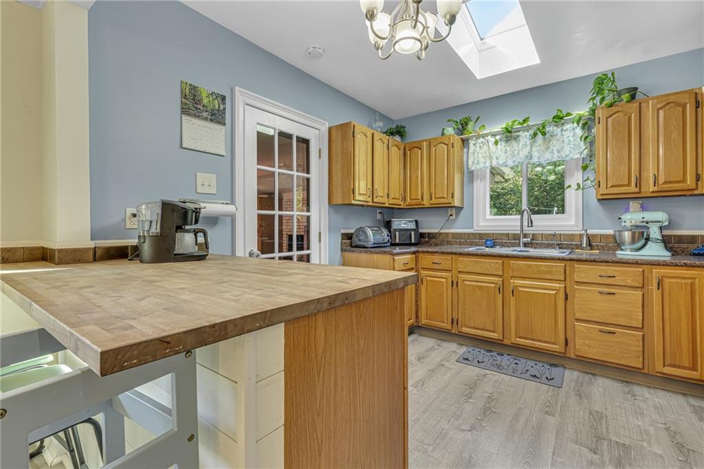 3430 37th St Extension Beaver Falls, PA 15010 - Photo 8 of 31 a kitchen with a stove a sink a dining table and chairs