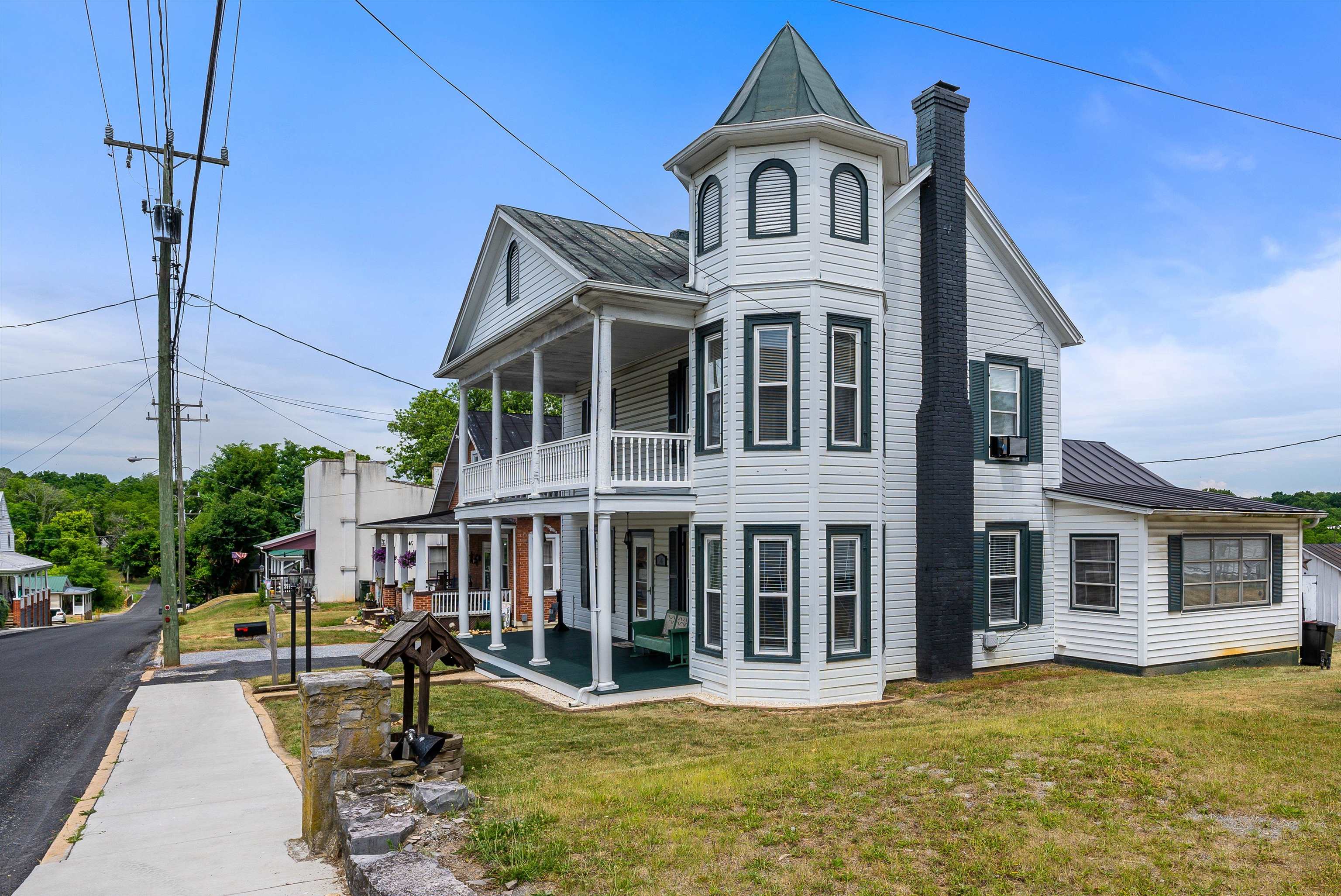 76 Main Street Greenville, VA 24440 - Photo 5 of 50 a view of a white house with a large windows and a yard with plants