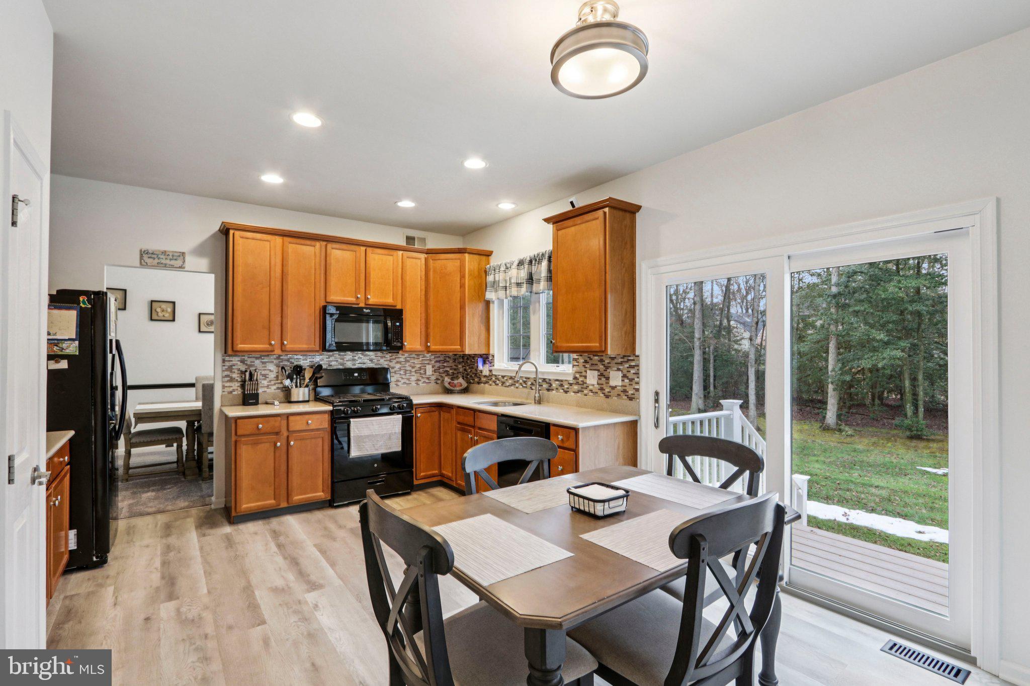 1 John's Way Bridgeton, NJ 08302 - Photo 28 of 57 a kitchen with a table chairs stove and refrigerator