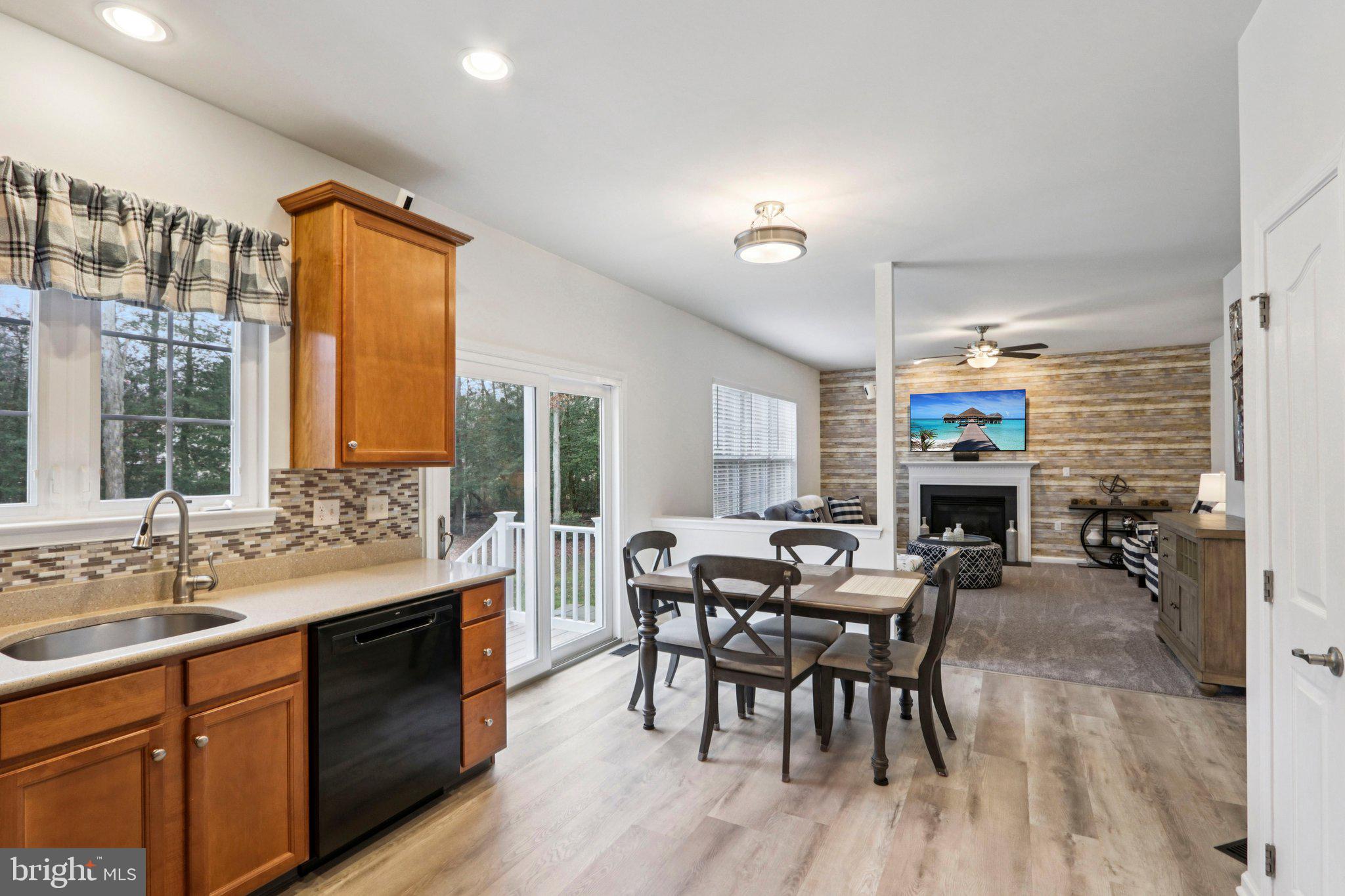 1 John's Way Bridgeton, NJ 08302 - Photo 30 of 57 a open kitchen with stainless steel appliances granite countertop a stove top oven a sink dishwasher a dining table and chairs with wooden floor
