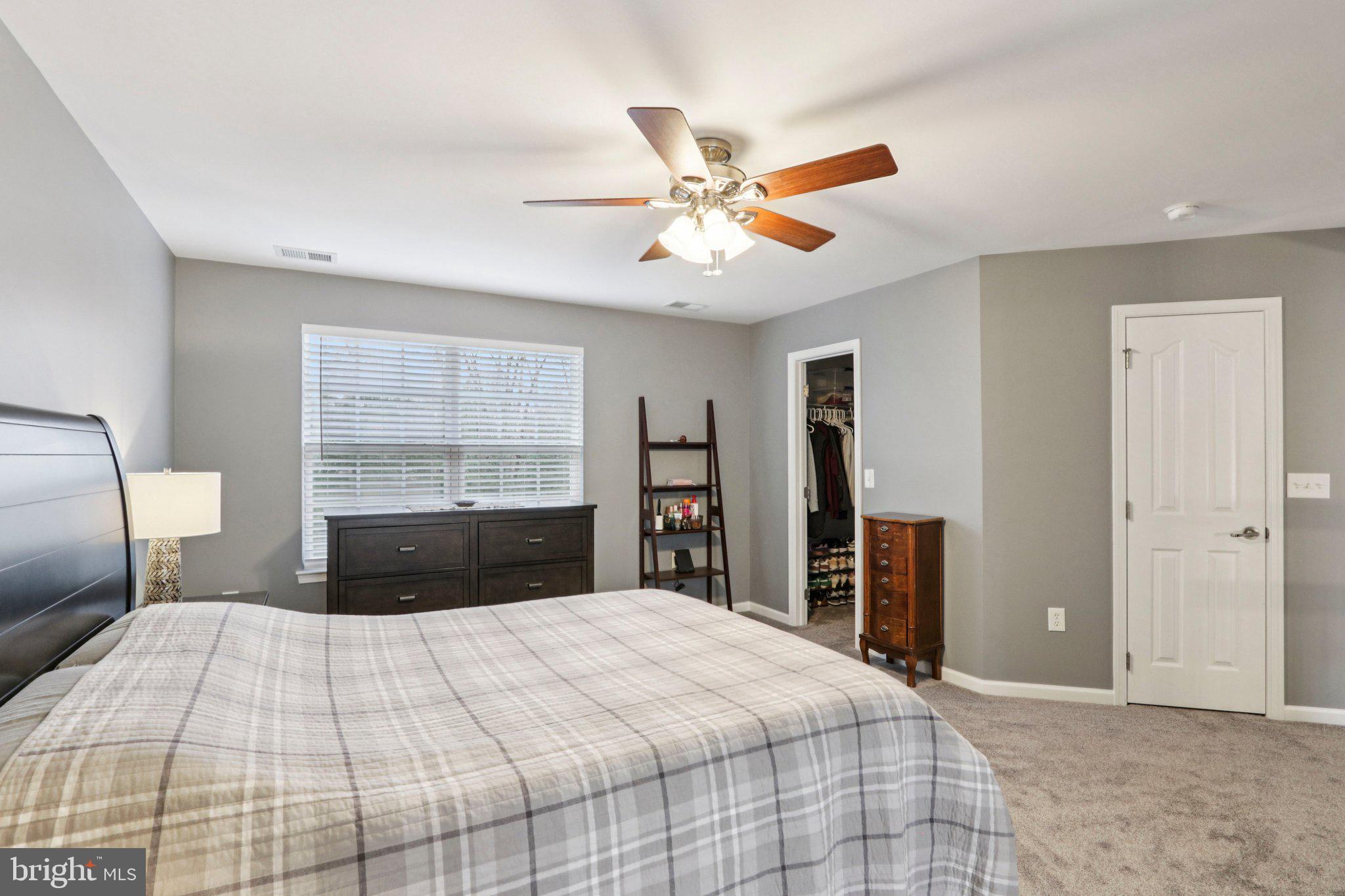 1 John's Way Bridgeton, NJ 08302 - Photo 39 of 57 a bedroom with a large bed and a chandelier