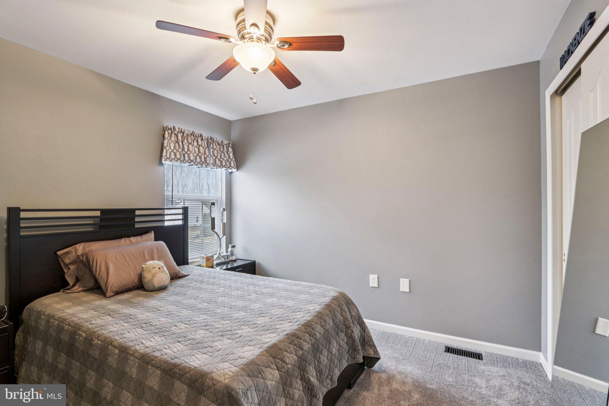 1 John's Way Bridgeton, NJ 08302 - Photo 50 of 57 a bedroom with a bed and a chandelier