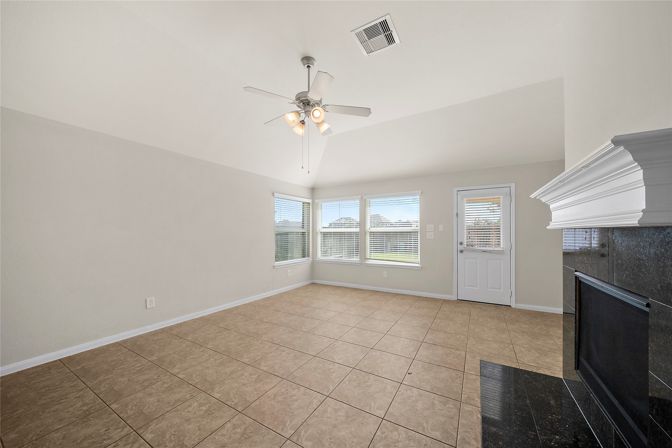 20215 Towering Cypress Drive Cypress, TX 77433 - Photo 12 of 27 a view of empty room with a fireplace and fan
