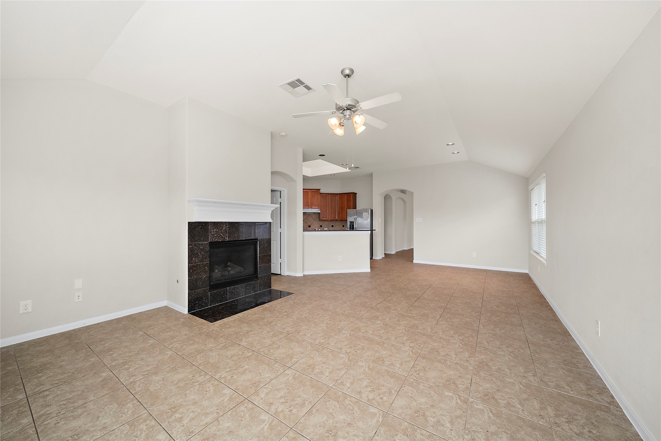 20215 Towering Cypress Drive Cypress, TX 77433 - Photo 13 of 27 an empty room with a fireplace and fan