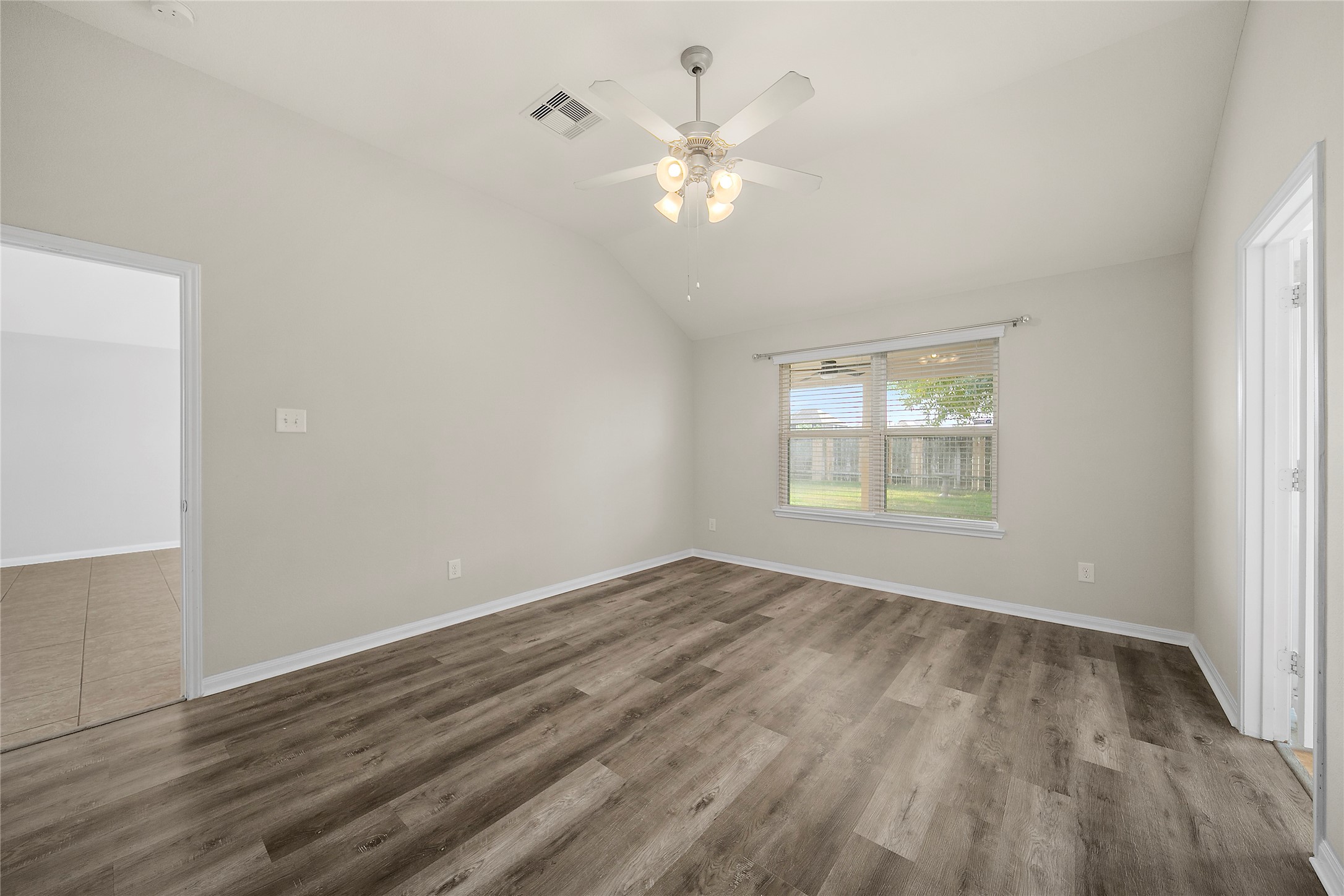 20215 Towering Cypress Drive Cypress, TX 77433 - Photo 16 of 27 an empty room with wooden floor and windows