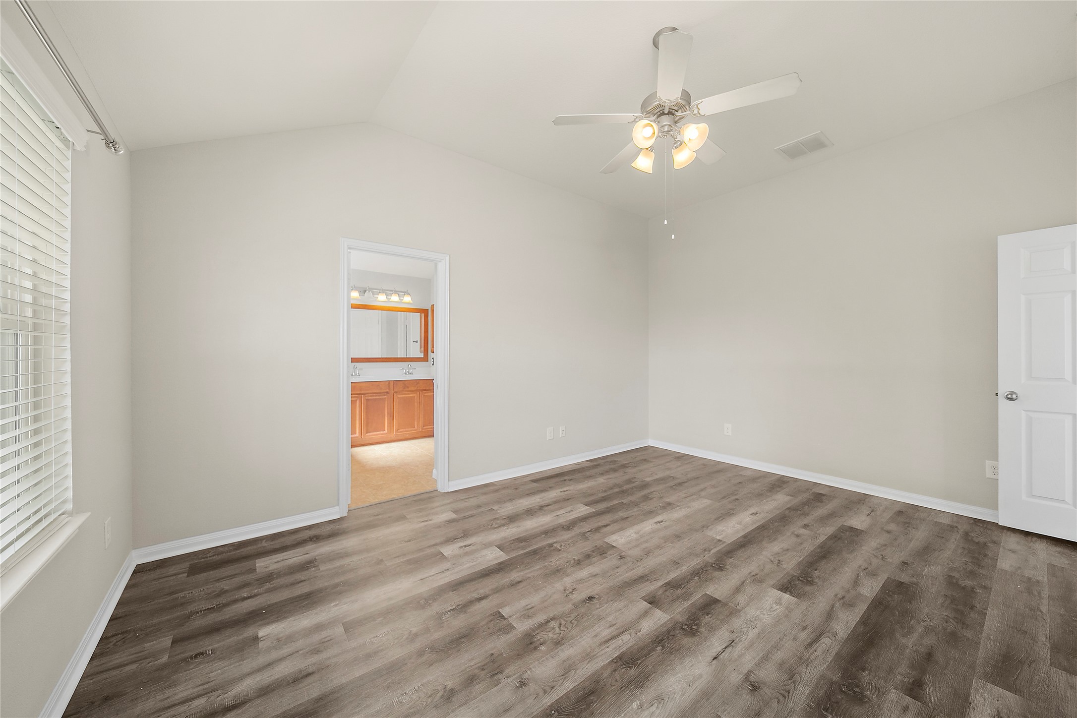 20215 Towering Cypress Drive Cypress, TX 77433 - Photo 17 of 27 a view of an empty room with wooden floor and a window